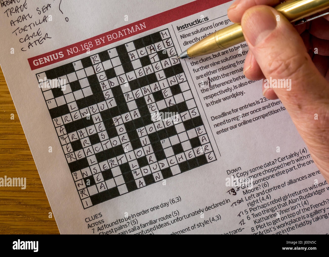 Solving Complicated Crossword Puzzle In The Guardian Newspaper Called Genius By Crossword Setter Nom De Plume Boatman With Man s Hand Holding Pen Stock Photo Alamy Solving Complicated Crossword Puzzle In The Guardian Newspaper Called Genius By Crossword Setter Nom De Plume Boatman With Man s Hand Holding Pen Stock Photo Alamy